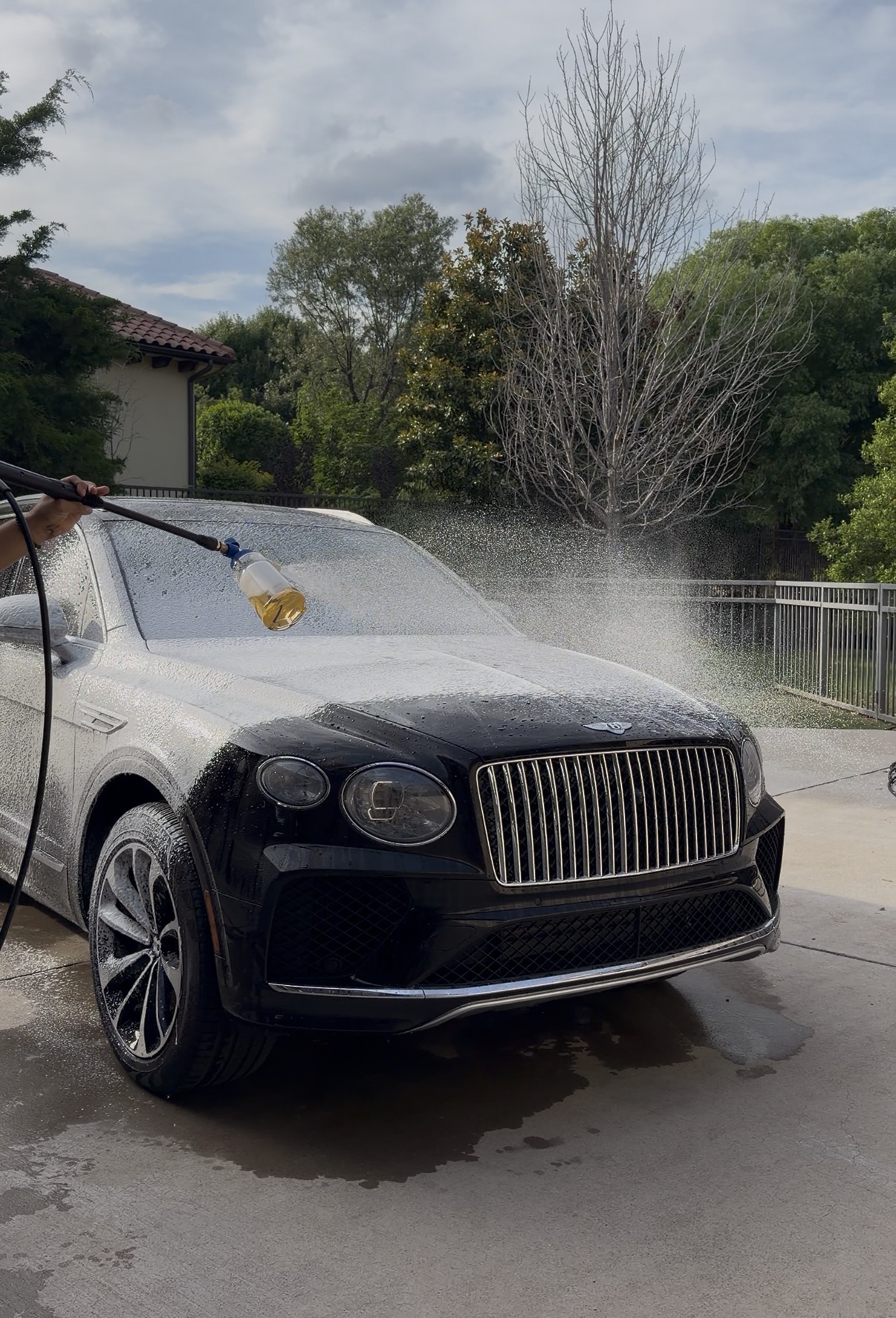 Luxury SUV covered in foam during an exterior wash